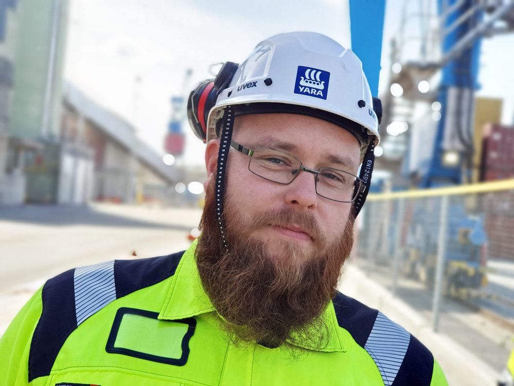 man with beard and white helmet at the quay