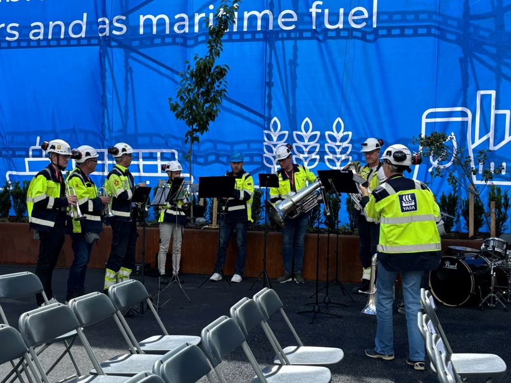 About 10 people playing brass instruments.