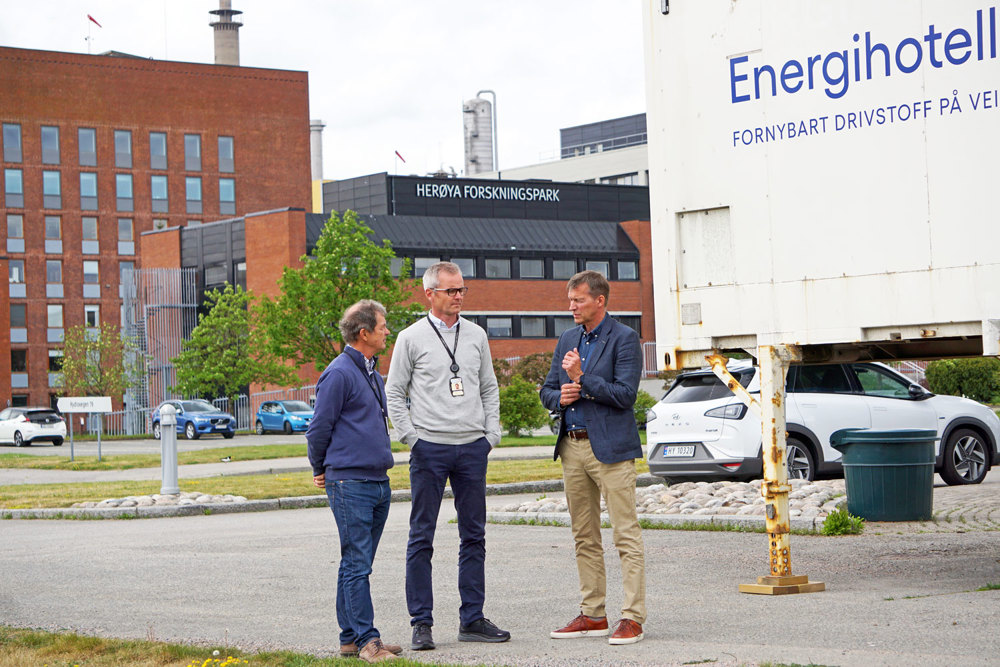 three men, parking space and container