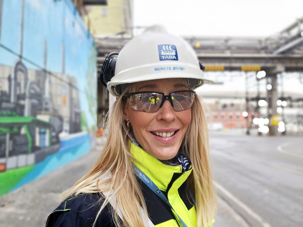 woman, long blond hair, portrait, posing, white helmet, outside, industry area