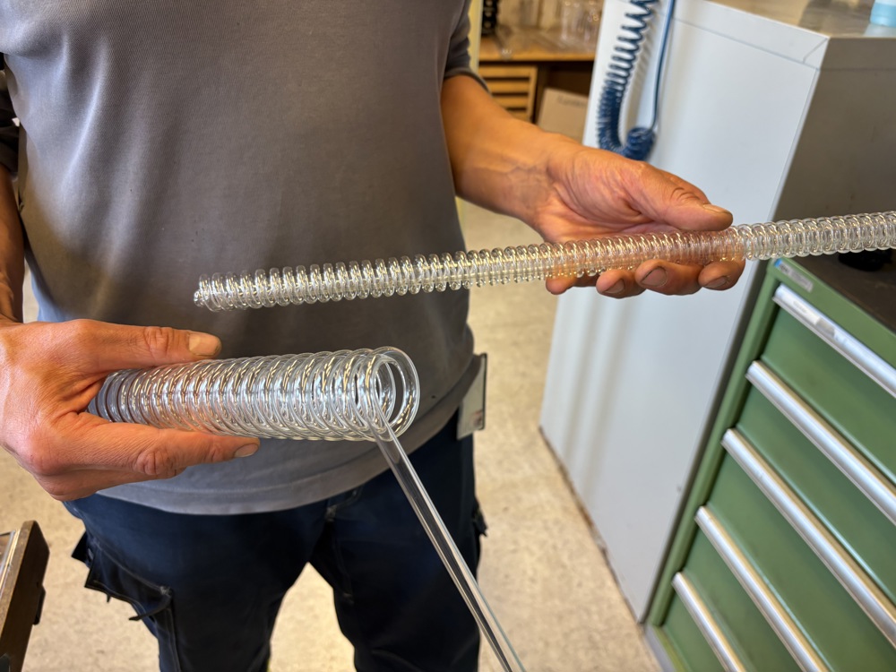 man holding coils of glass in his hands