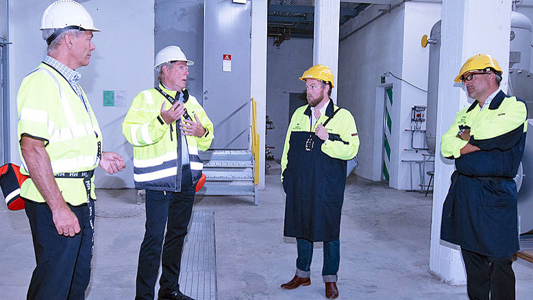 four men talking in a pilot hall