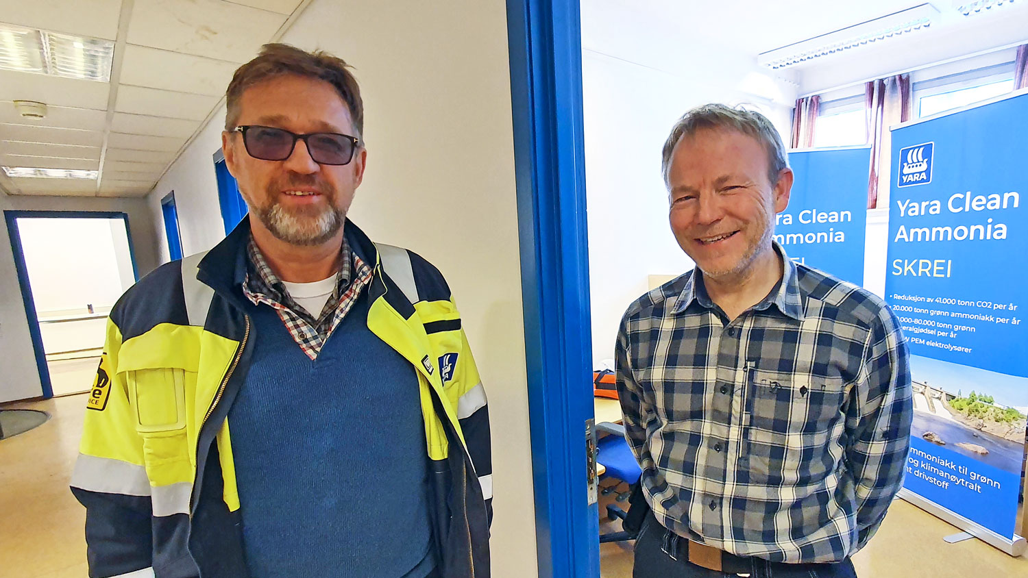 two men standing in office area