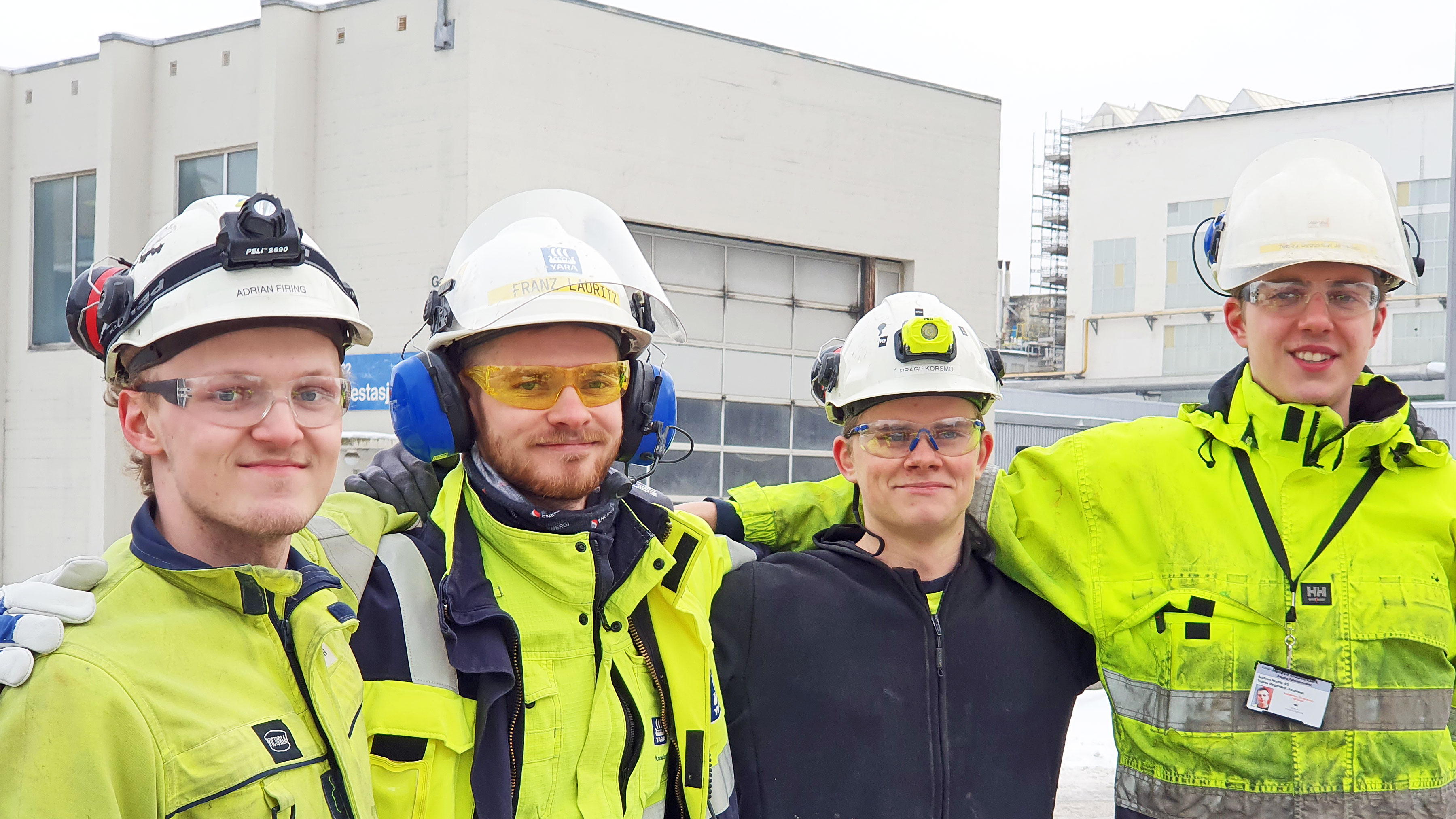 four young men, close together, apprentices