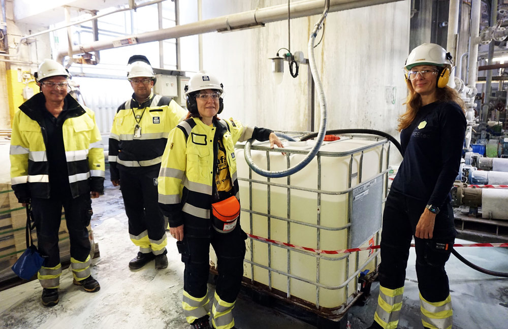 four people wearing protective equipment in a pilot hall